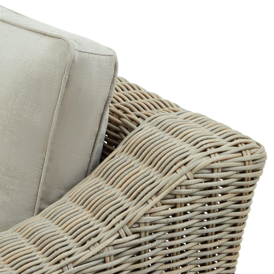 Beige all-weather wicker armchair with HDPE weave, aluminum frame, and acacia wood feet for outdoor luxury. by Sostter at brixbailey.com