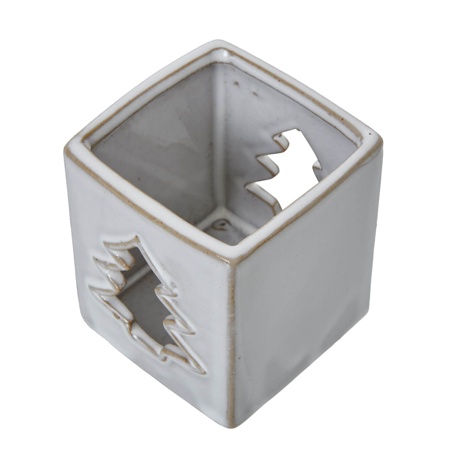 White ceramic tealight holder with intricate tree cut-outs casting warm glow patterns, minimalist home decor by Sostter at brixbailey.com