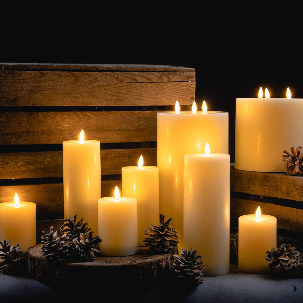 Realistic ivory LED candle with warm flickering glow, wax-like finish, and timer for flame-free ambiance by RoomLondon at brixbailey.com