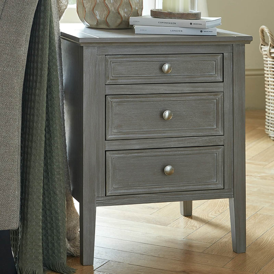 Distressed grey three-drawer bedside table, solid wood with smooth-gliding drawers for bedroom storage. by Sostter at brixbailey.com