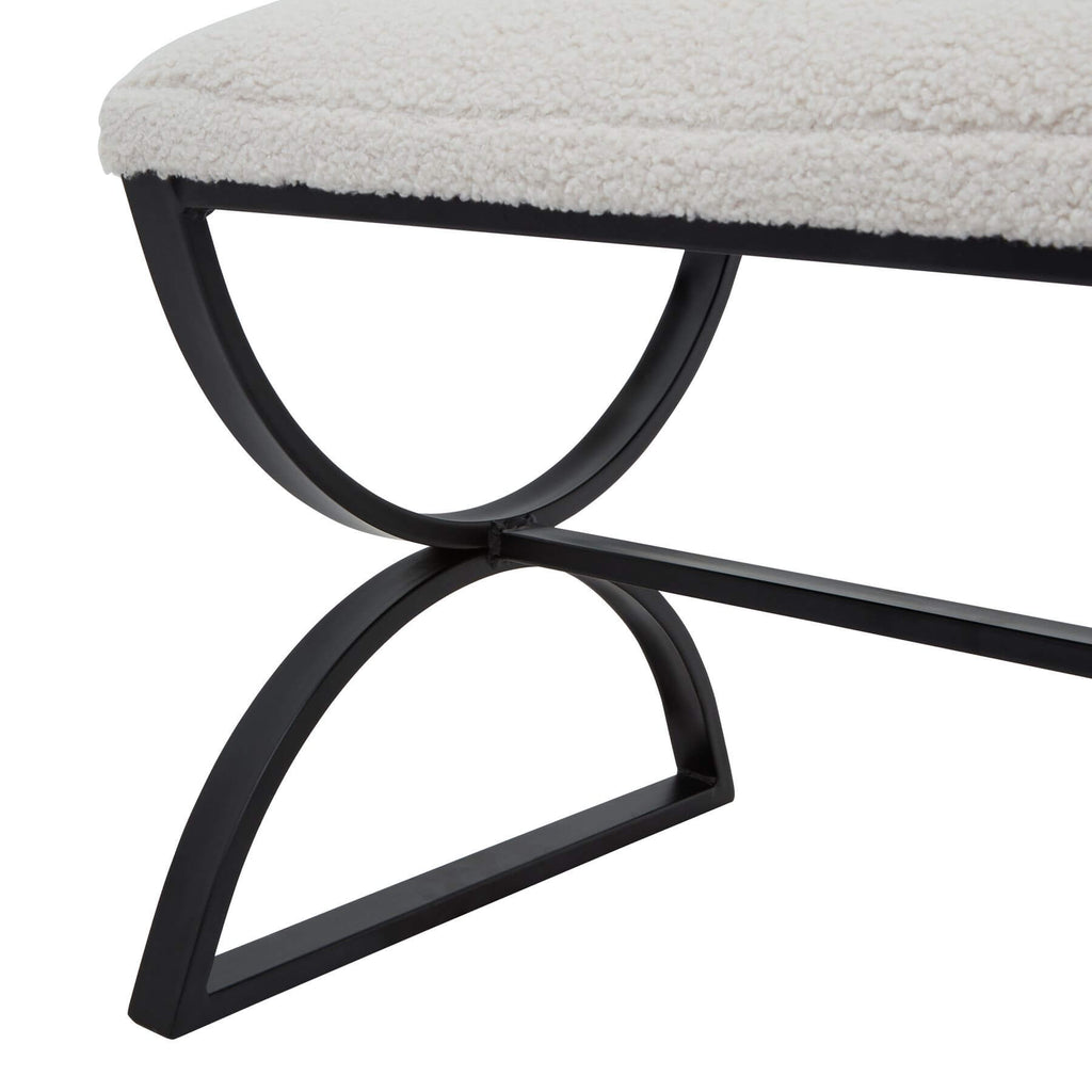 Cream boucle ribbed footstool with black metal curved legs, plush textured upholstery, and modern design by Sostter at brixbailey.com
