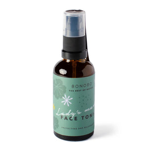bold close-up of lady's mantle face tonic bottle catching the sunrise light