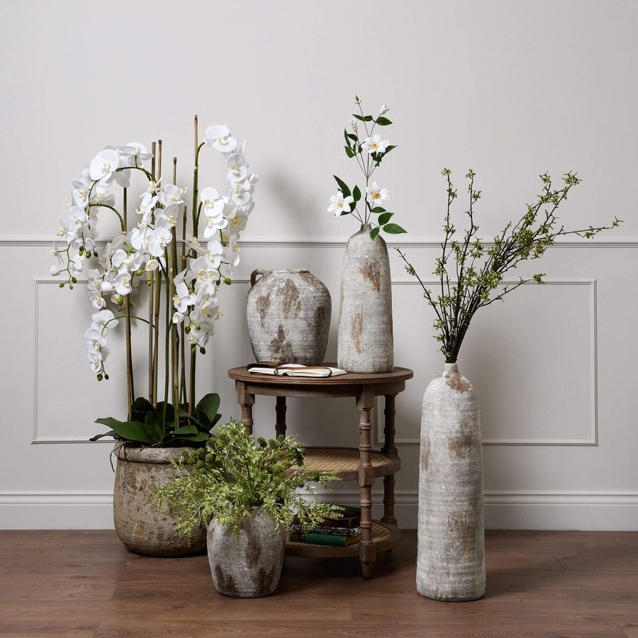 5ft white artificial orchid in distressed stone pot with lifelike blooms and green leaves by Sostter at brixbailey.com
