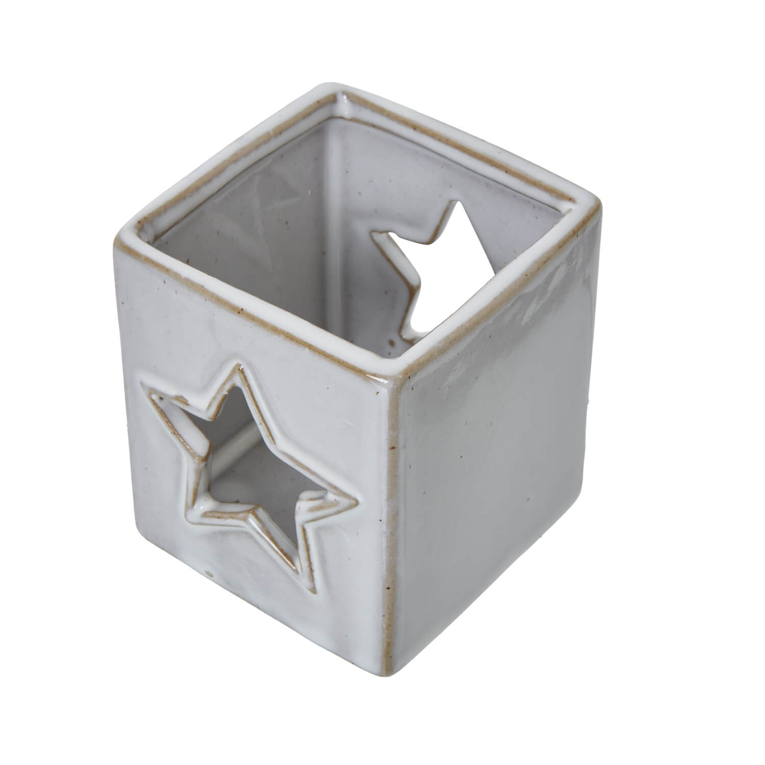 White ceramic tealight holder with star cut-outs casting delicate light patterns, minimalist home decor by sostter at brixbailey.com