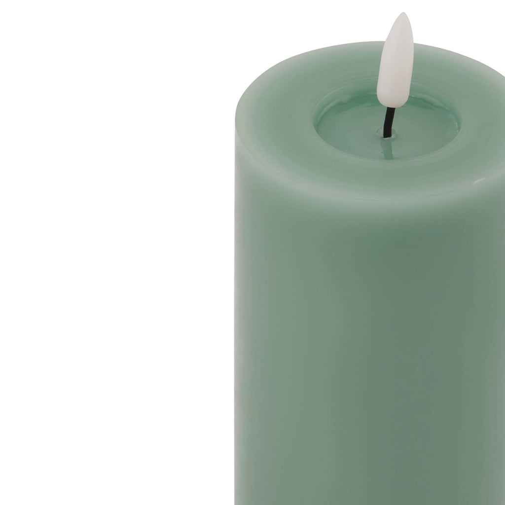 Realistic sage green LED candle with dripping wax effect, battery-operated for flameless ambiance. by Sostter at brixbailey.com