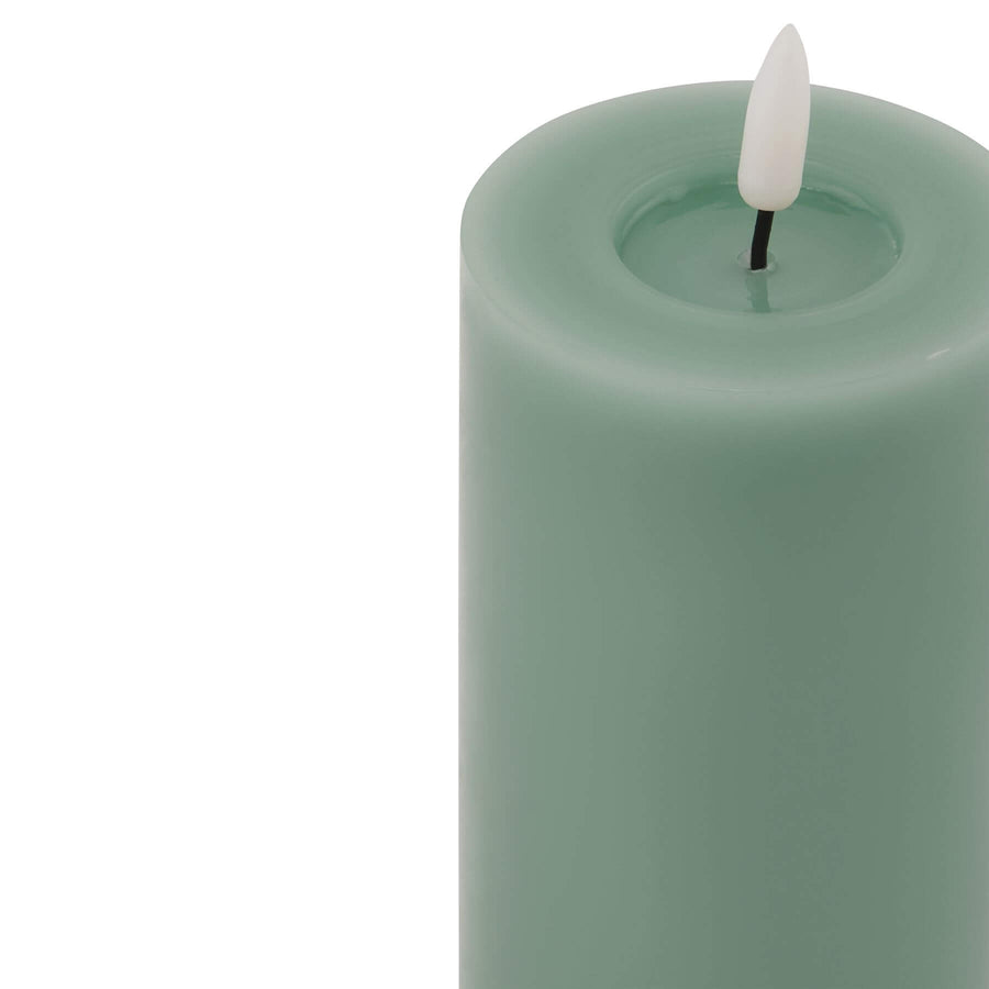 Realistic sage green LED candle with dripping wax effect, battery-operated for flameless ambiance. by Sostter at brixbailey.com