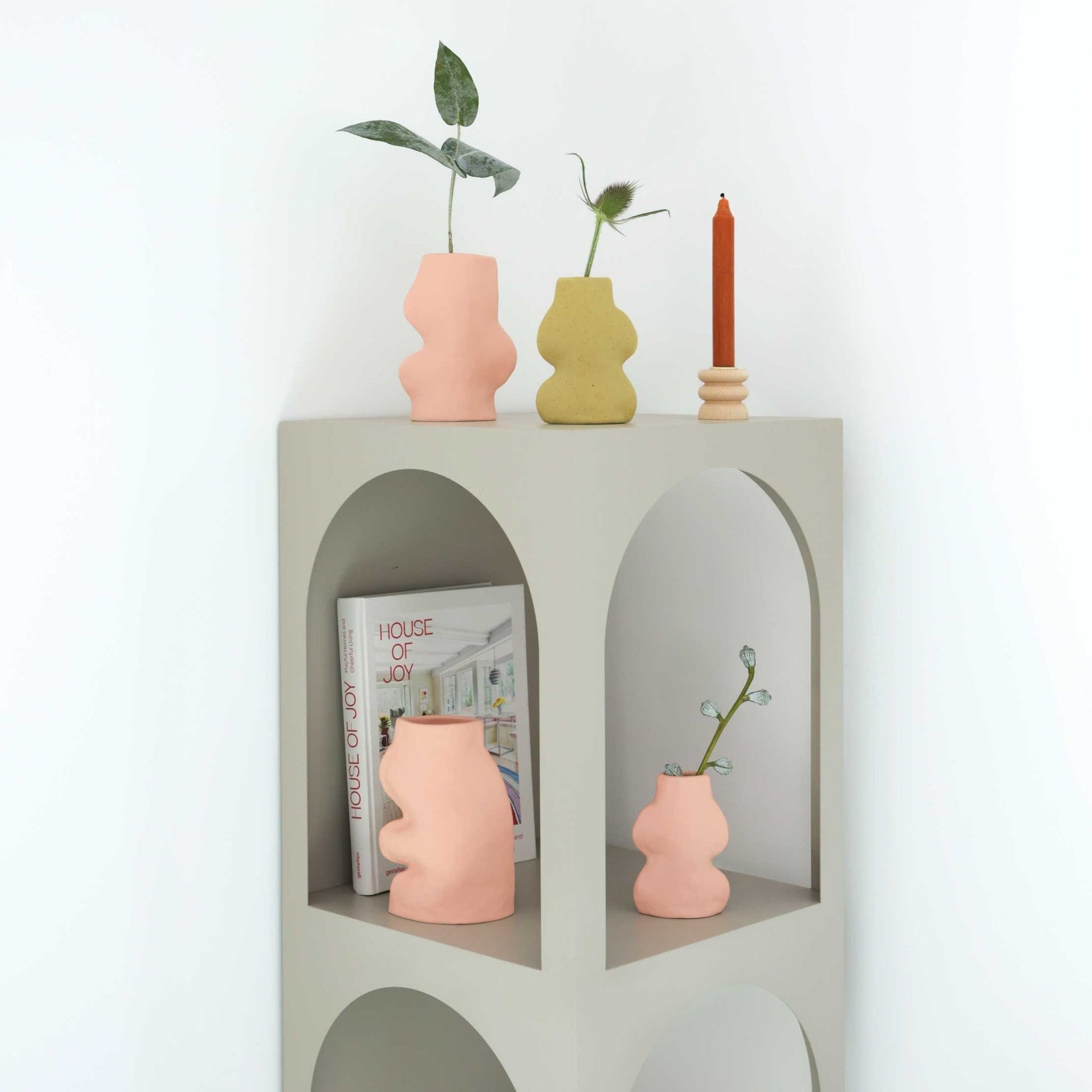 playful pink ceramic fluxo vase on a sunlit windowsill, casting a soft shadow