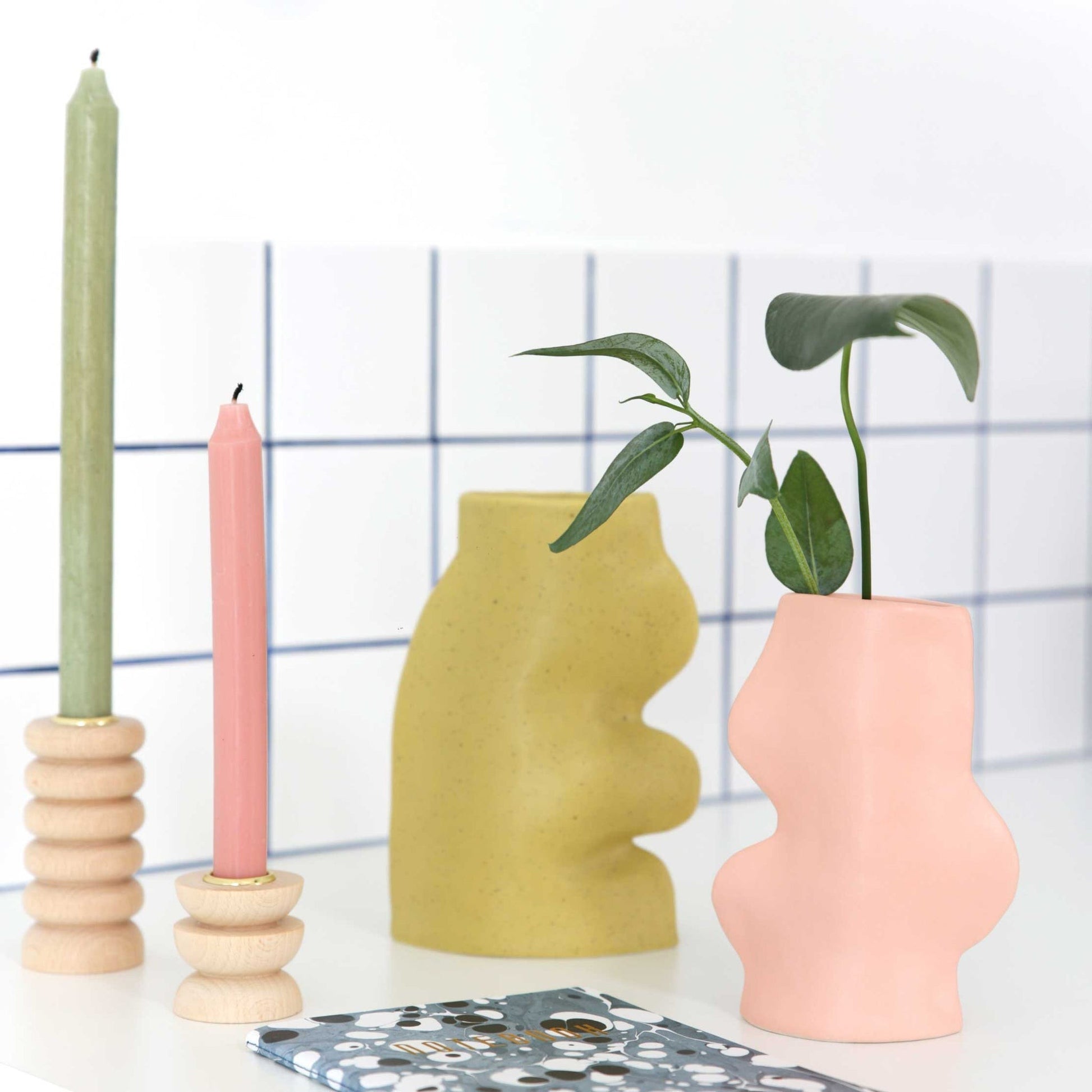 elegant pink ceramic fluxo vase on a marble surface in soft morning light