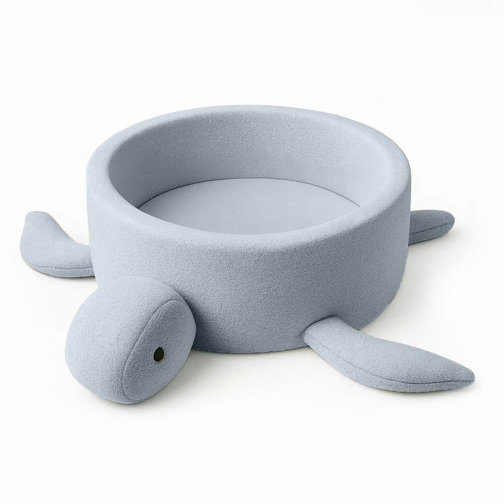a soft dusty ice blue turtle ball pit with cozy boucle fabric, perfect for a baby's nursery