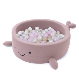 bold raspberry pink whale ball pit with plush boucle texture in a bright nursery