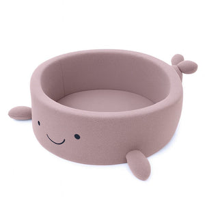 soft raspberry pink boucle whale ball pit for a baby's cozy nursery corner
