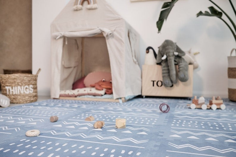 bold azure boho foam playmat in dramatic low-angle shot for stylish nursery