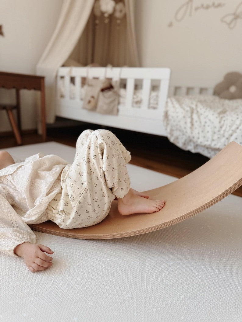 a close-up of soft foam puzzle tiles in spots cashmere, arranged playfully on a bright nursery floor