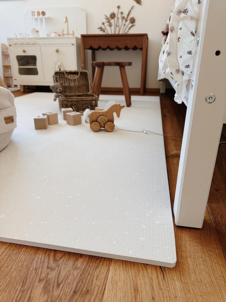 elegant spots cashmere foam playmat in soft morning light, a refined nursery essential