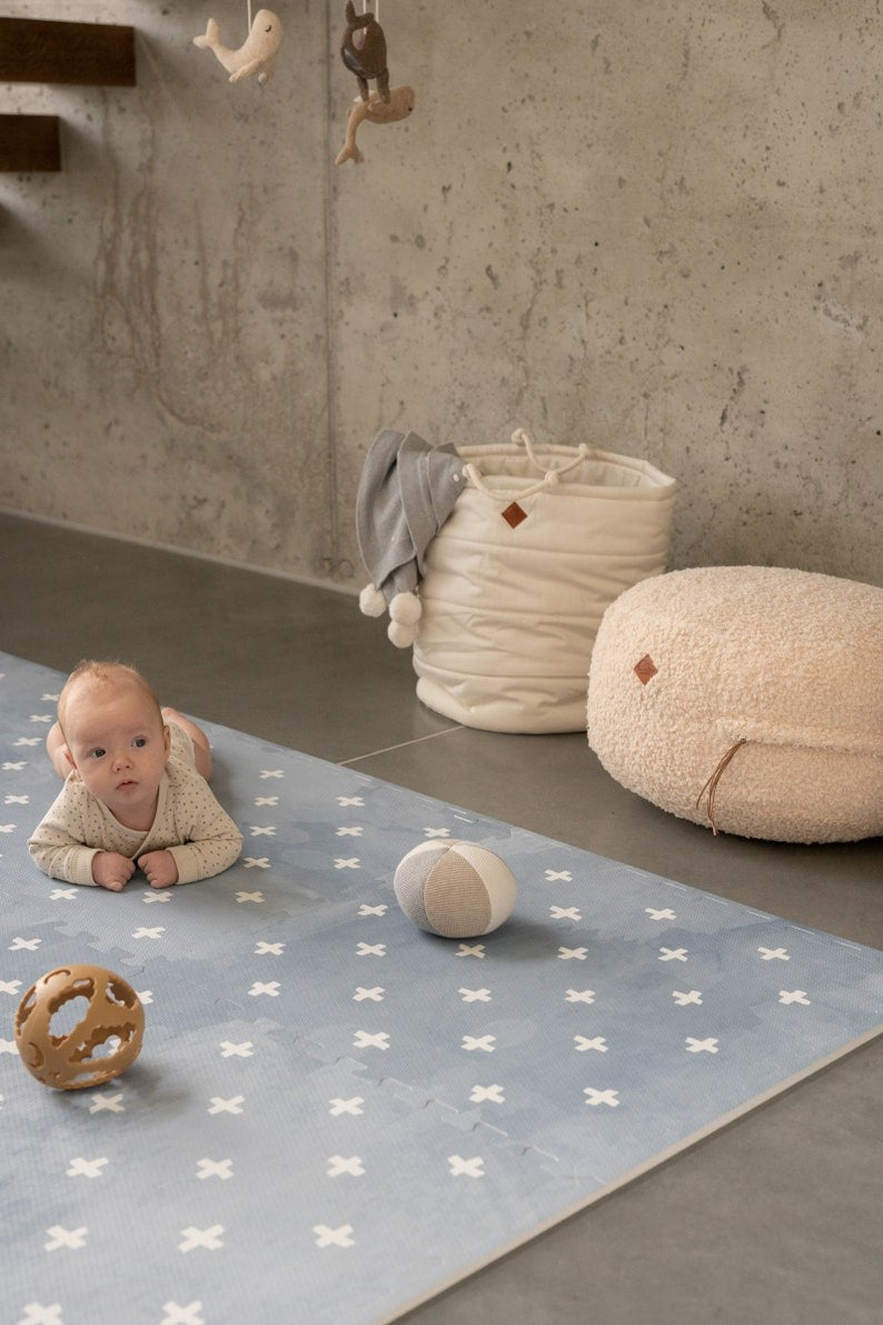 a close-up detail of the cross azure foam playmat showing its wipe-clean surface and safe eva foam construction