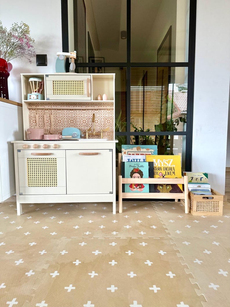 close-up of a neutral cross sand foam playmat tile with soft morning light