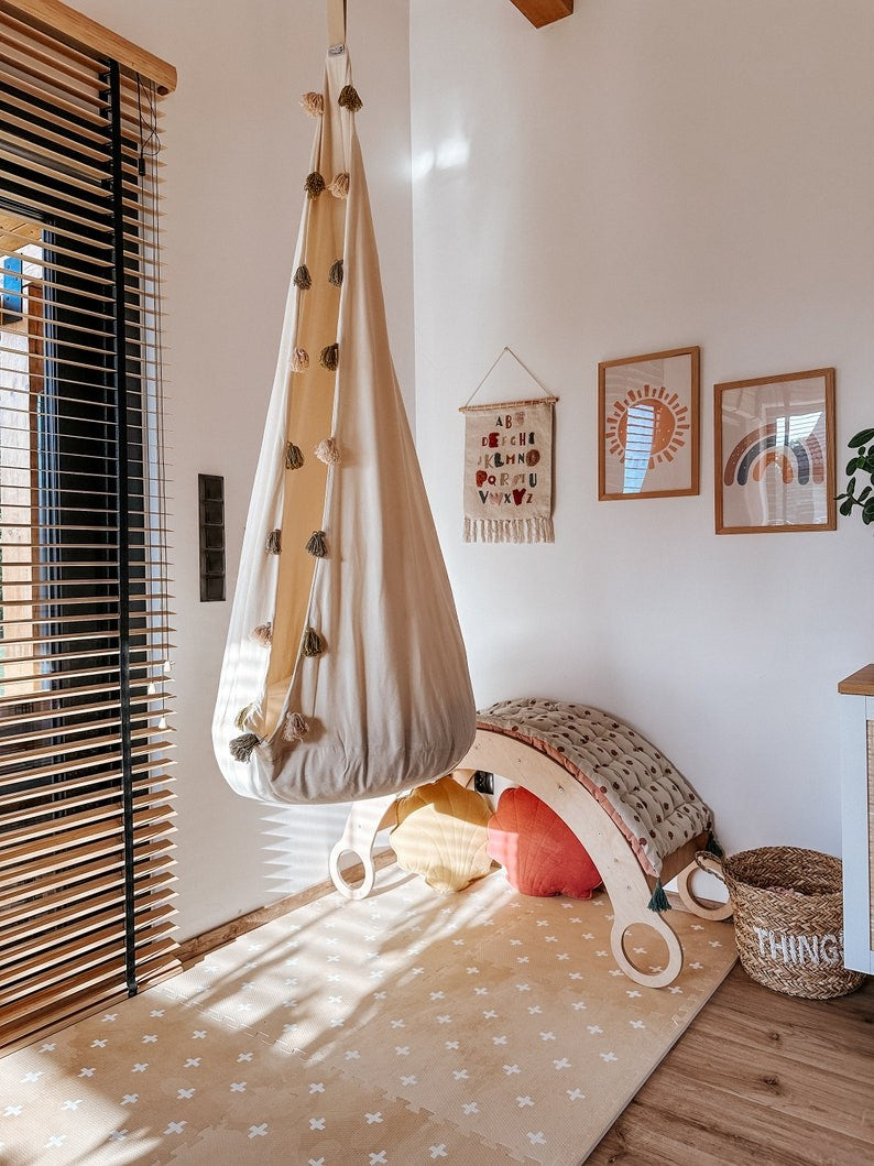 close-up of a stylish cross sand foam playmat in soft neutral tones