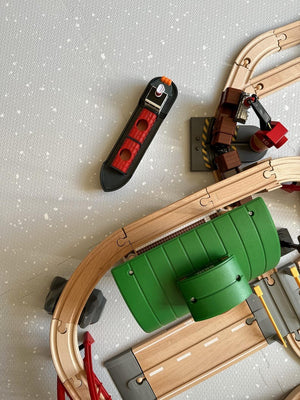 a dove grey baby playmat with soft foam spots in elegant low lighting