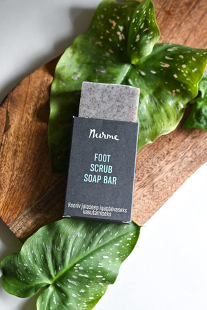 bold close-up of revitalizing foot scrub soap bar with visible pumice and almond shell exfoliants
