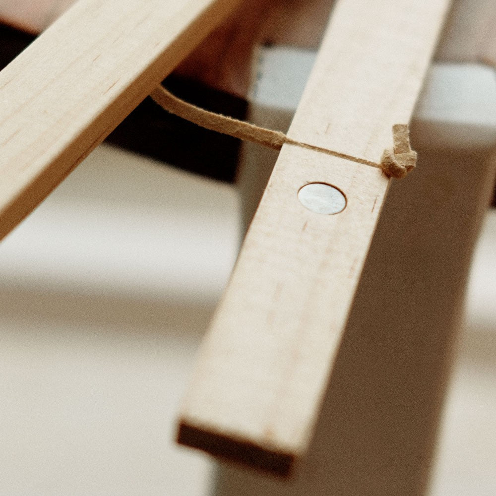a soft-lit pine wood poster frame with a minimalist print in a cozy home setting