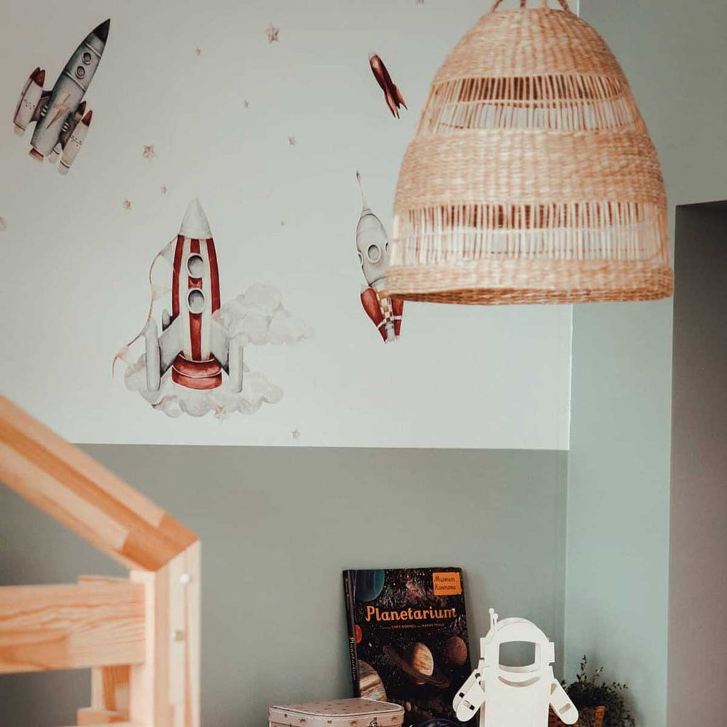 a practical layout guide showing how to arrange the watercolor rocket and planet wall stickers on a clean wall