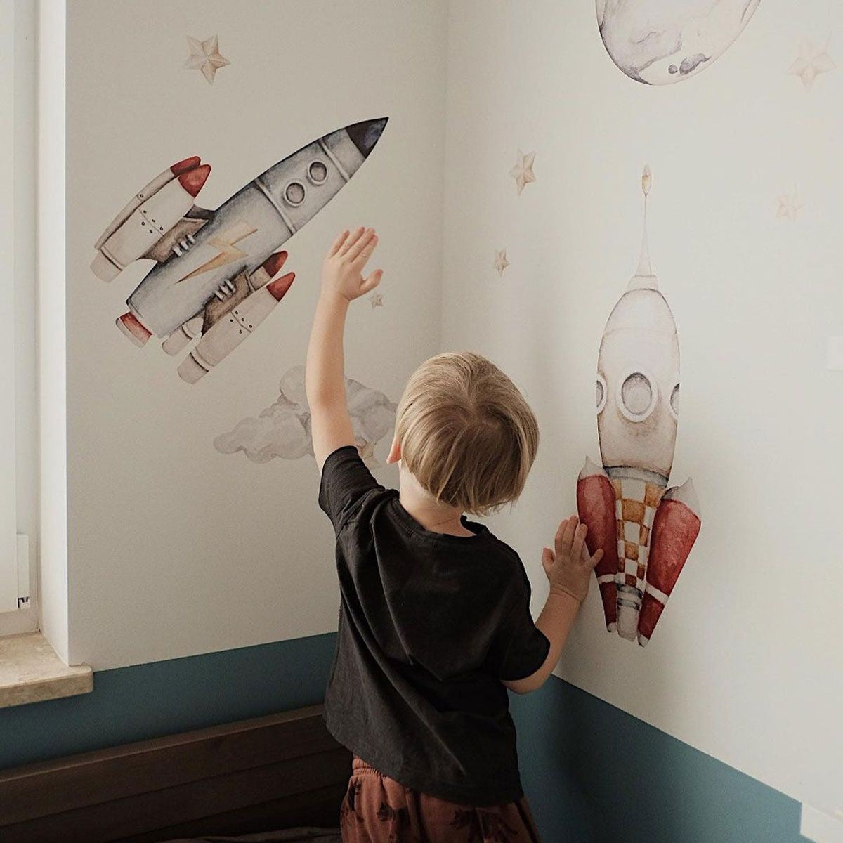 a playful watercolor rocket ship soaring through a dreamy cosmos of stars and planets
