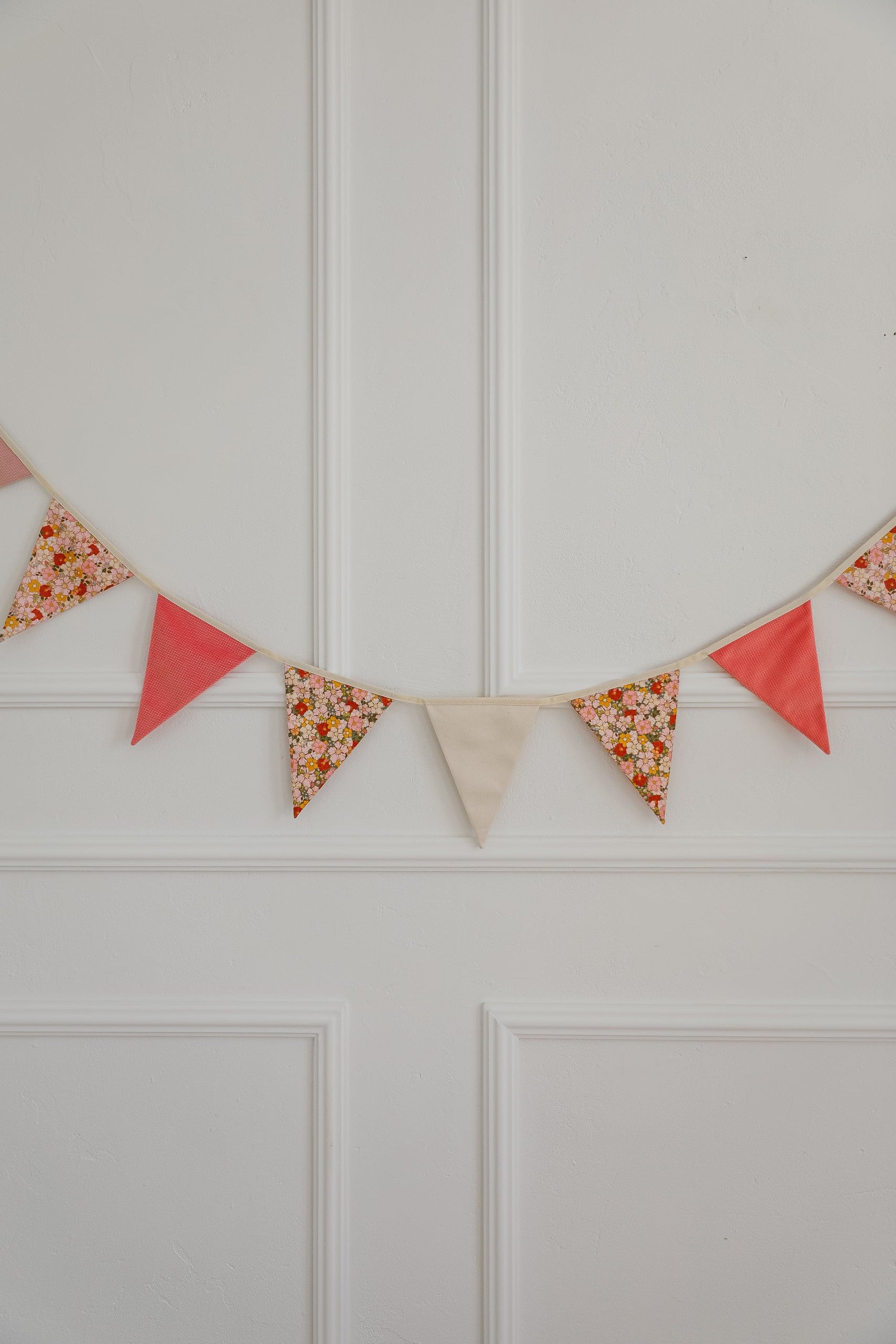 powder mint cotton-velvet birthday garland draped over a rustic wooden crib in soft sunlight