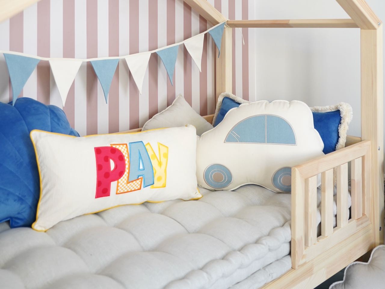 soft cotton and linen garland with 9 charming pendants, gently draped over a wooden crib in a cozy nursery