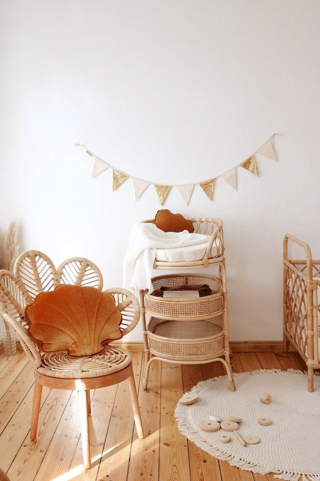 gold and beige sequin garland with nine cotton pendants on a cozy window