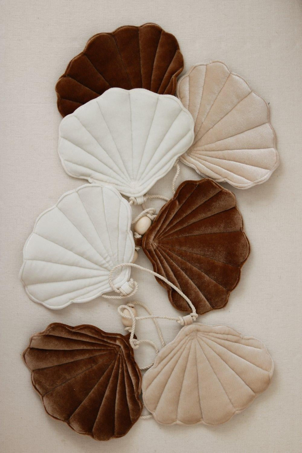 beige pearl shell garland laid flat showing full 3-meter length and detailed wooden beads