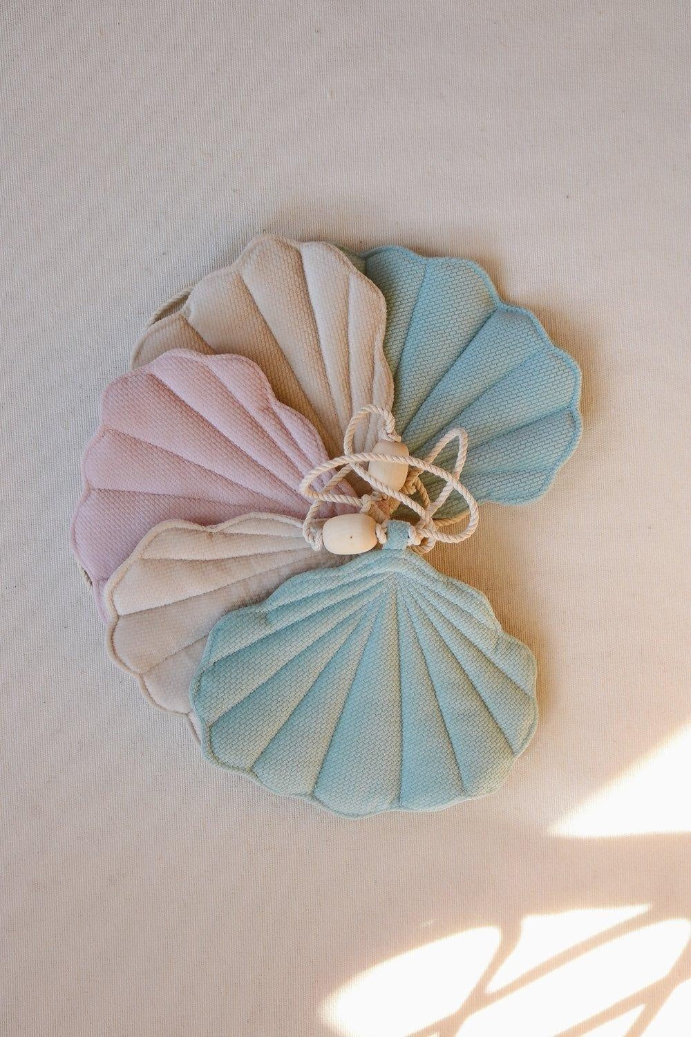 elegant shell garland with velvet pendants and wooden beads, draped gracefully for a refined summer decor
