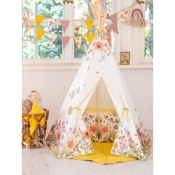 elegant wildflower garland draped over a linen canopy in soft morning light