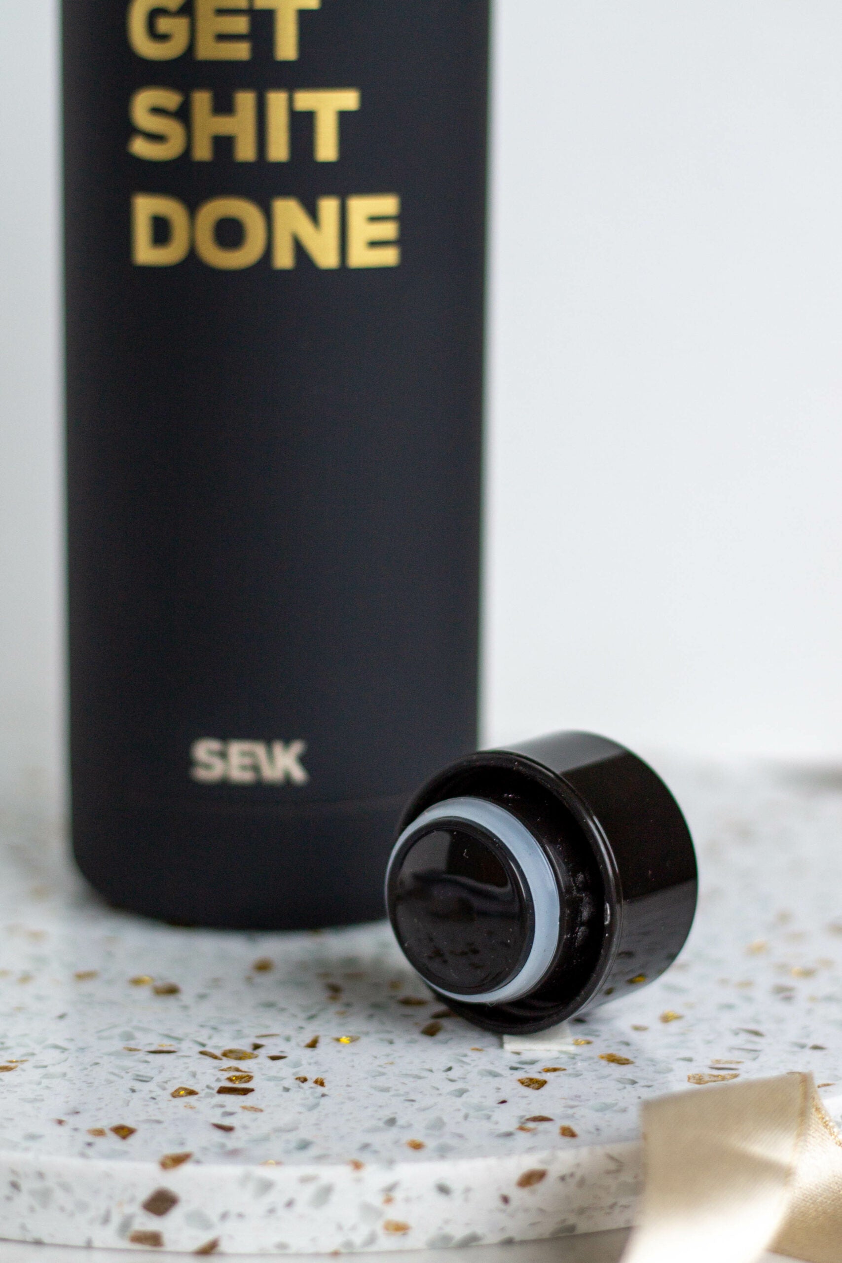bold black seik 500ml stainless steel water bottle on a dark granite surface