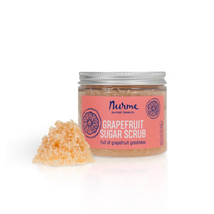 close-up of soft pink grapefruit sugar scrub in a jar with gentle morning light