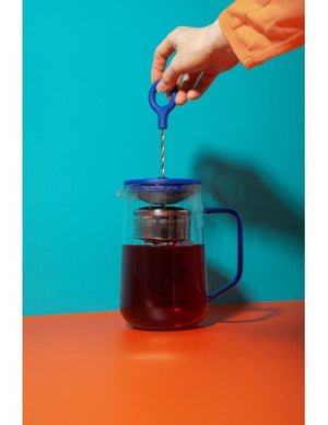 bold blue gyro teapot showcasing its mesmerizing swirling tea infusion in dramatic light