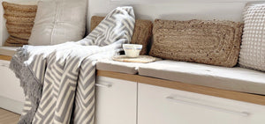 a soft gray haakla pet blanket with a close-up of its comforting textured weave