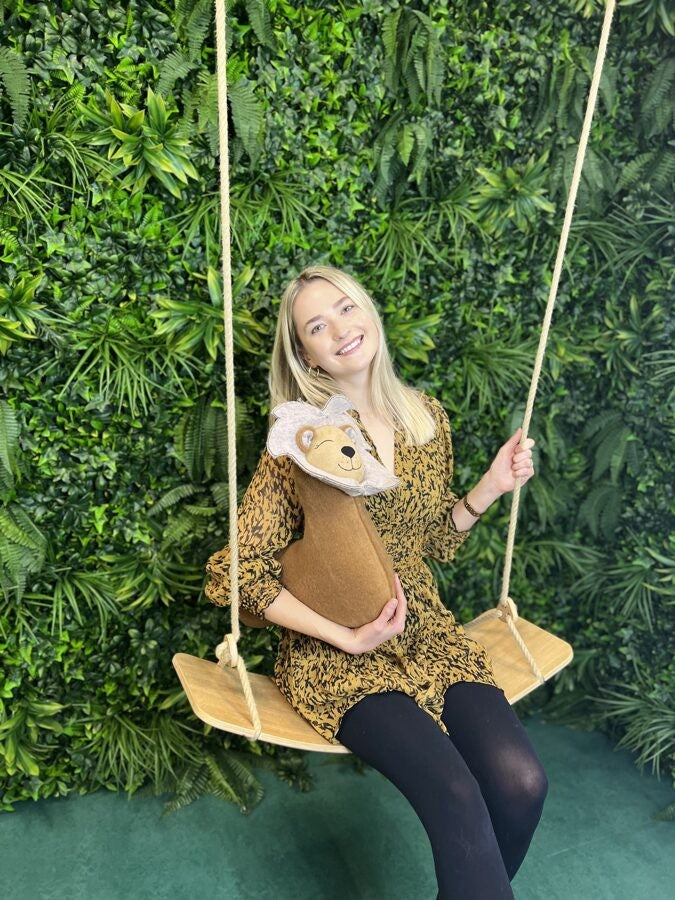 a soft handmade lion pillow in warm lamplight, perfect for a child's bedtime cuddle