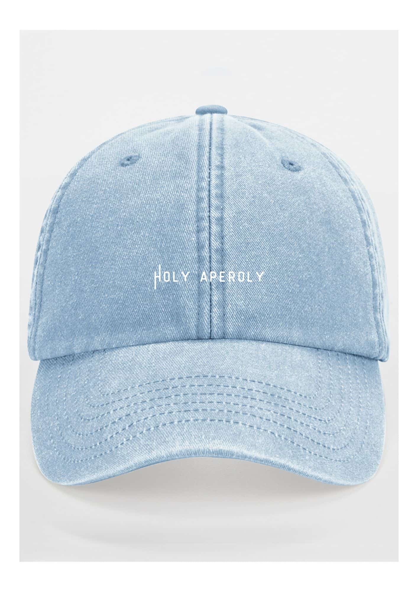 a bold close-up of a pastel cotton cap with a vintage brass buckle in sharp focus