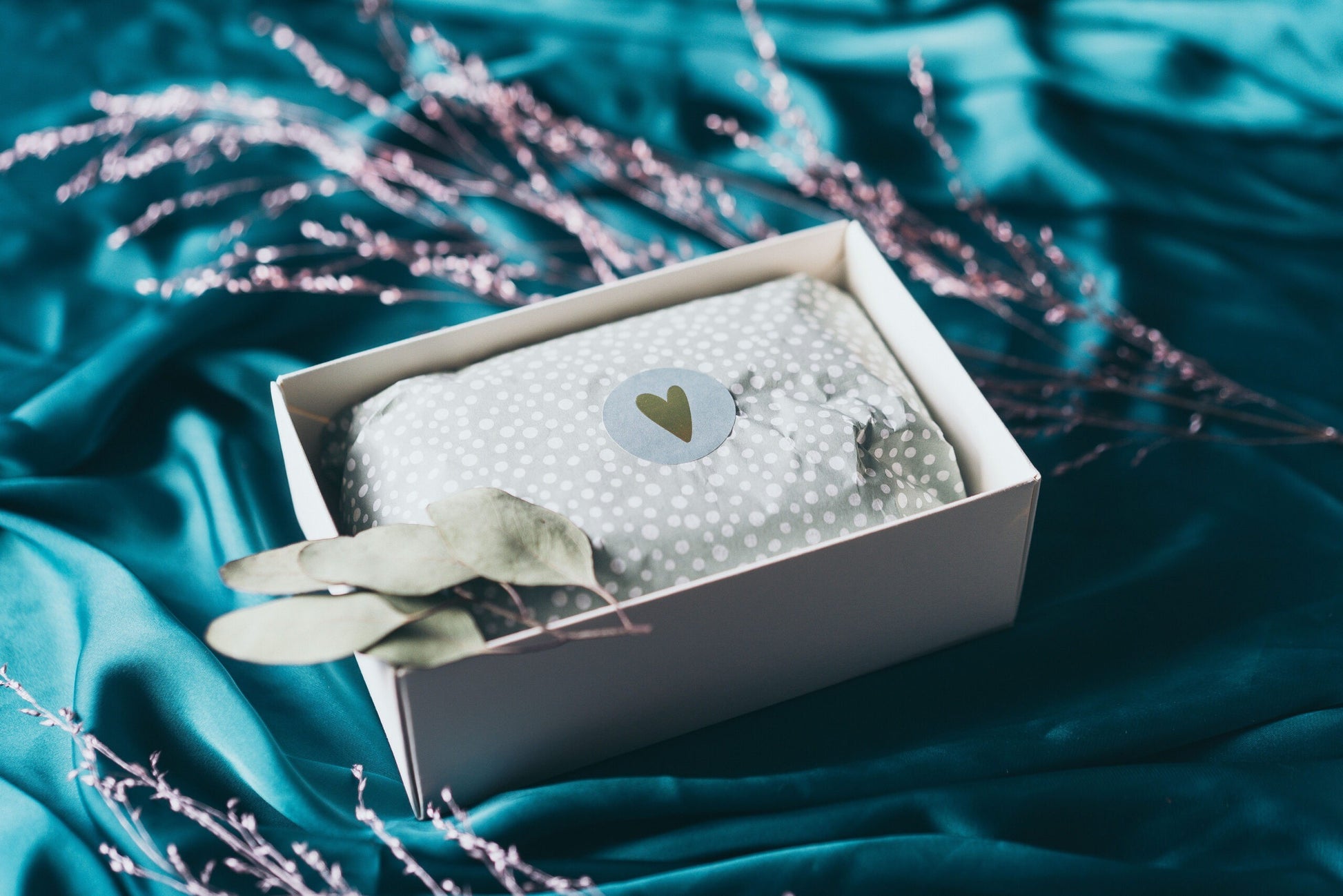 elegant i see you gift box with juniper candle and orange cream on a minimalist table