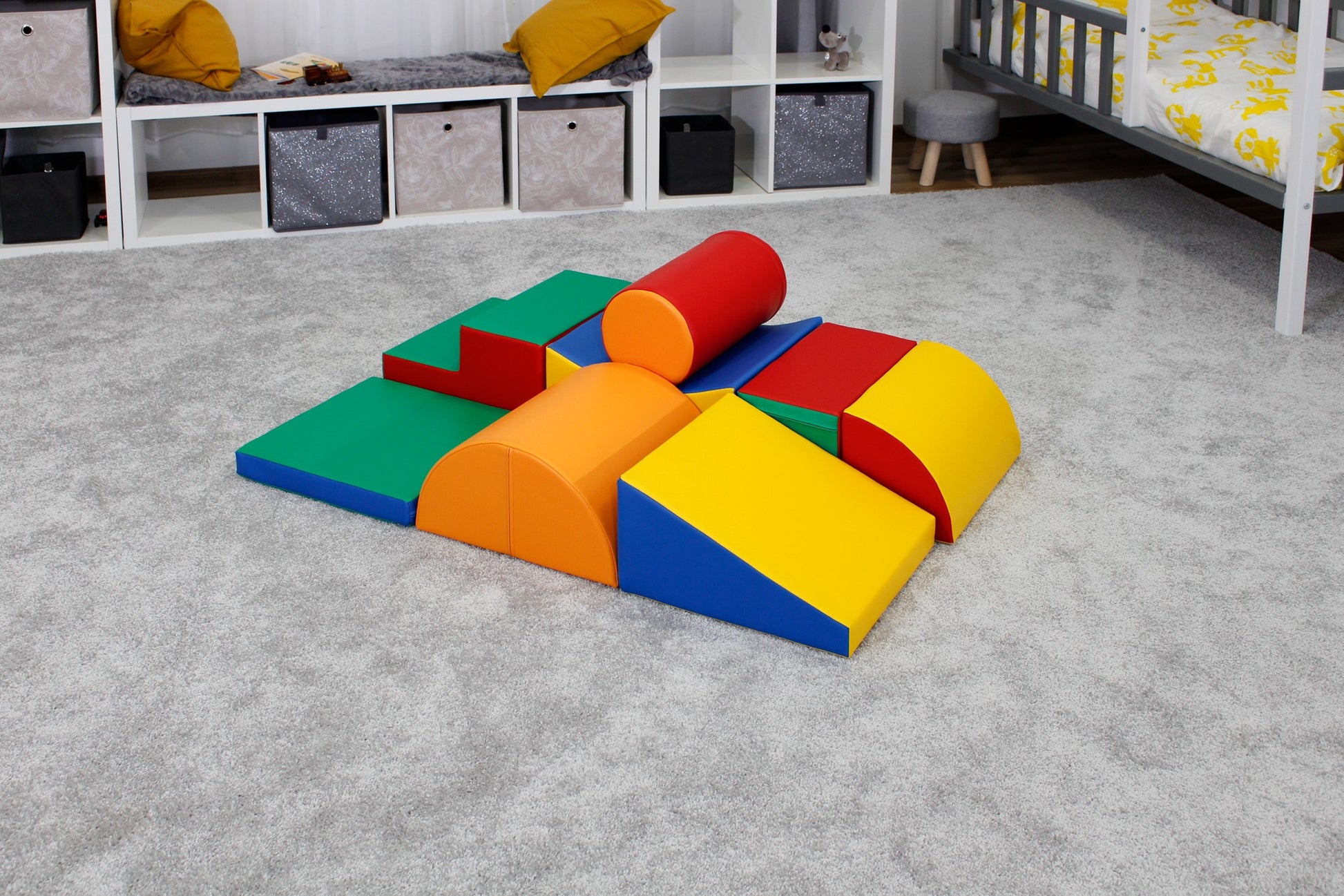 a child building a vibrant iglu soft block tower on a hardwood floor