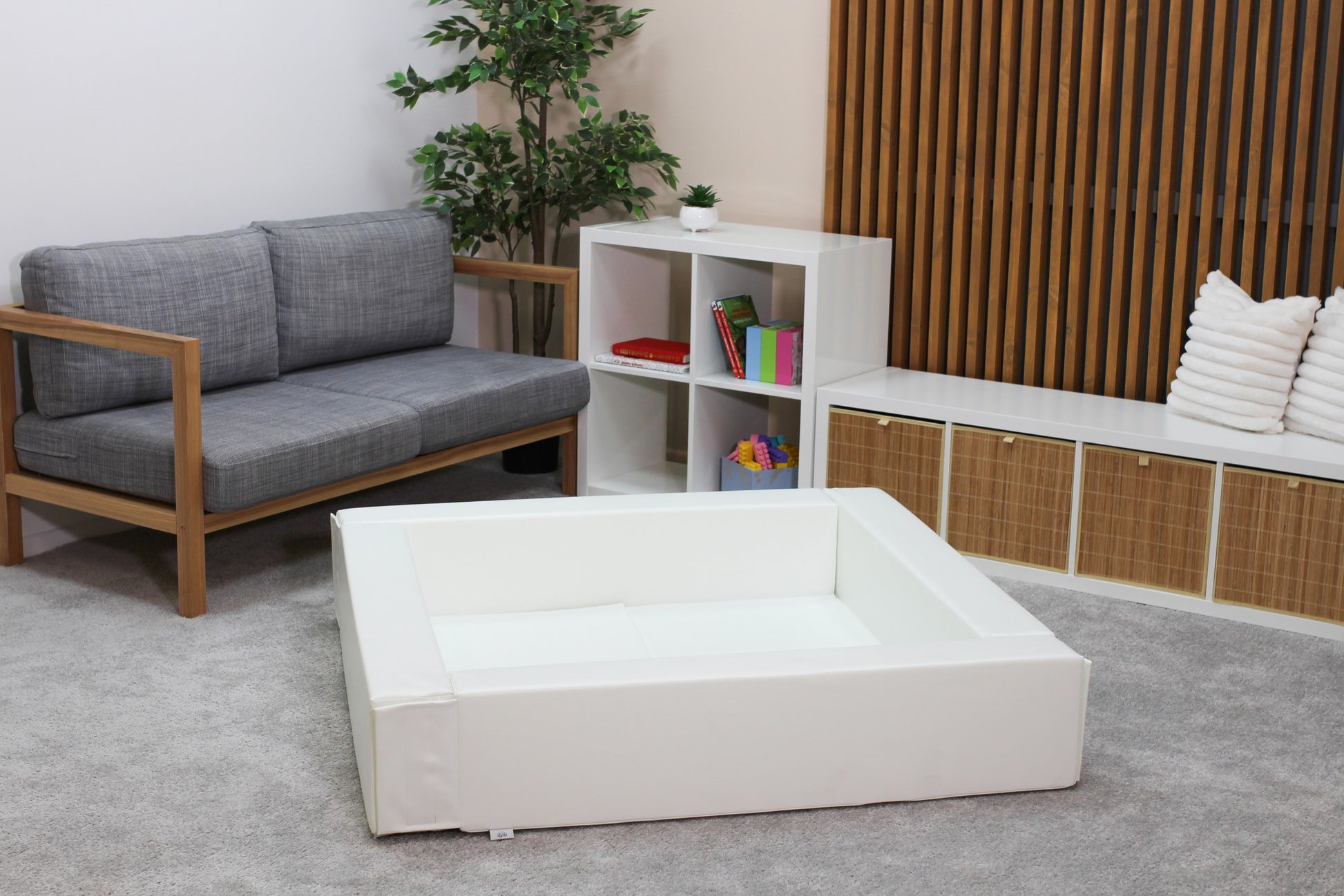 soft white foam ball pit for toddlers in a cozy, sunlit nursery corner