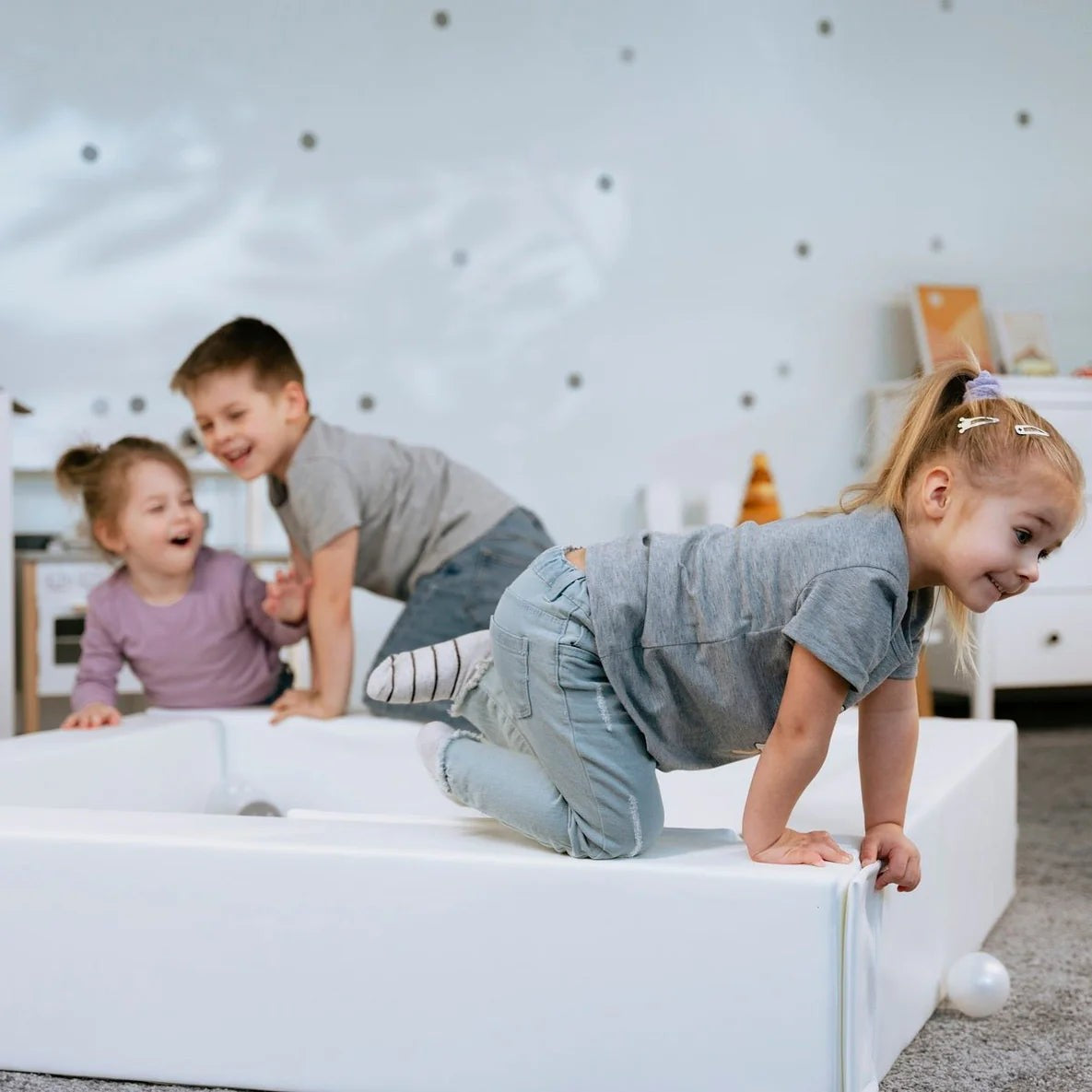 bold white iglu soft play ball pit for kids in a bright modern nursery