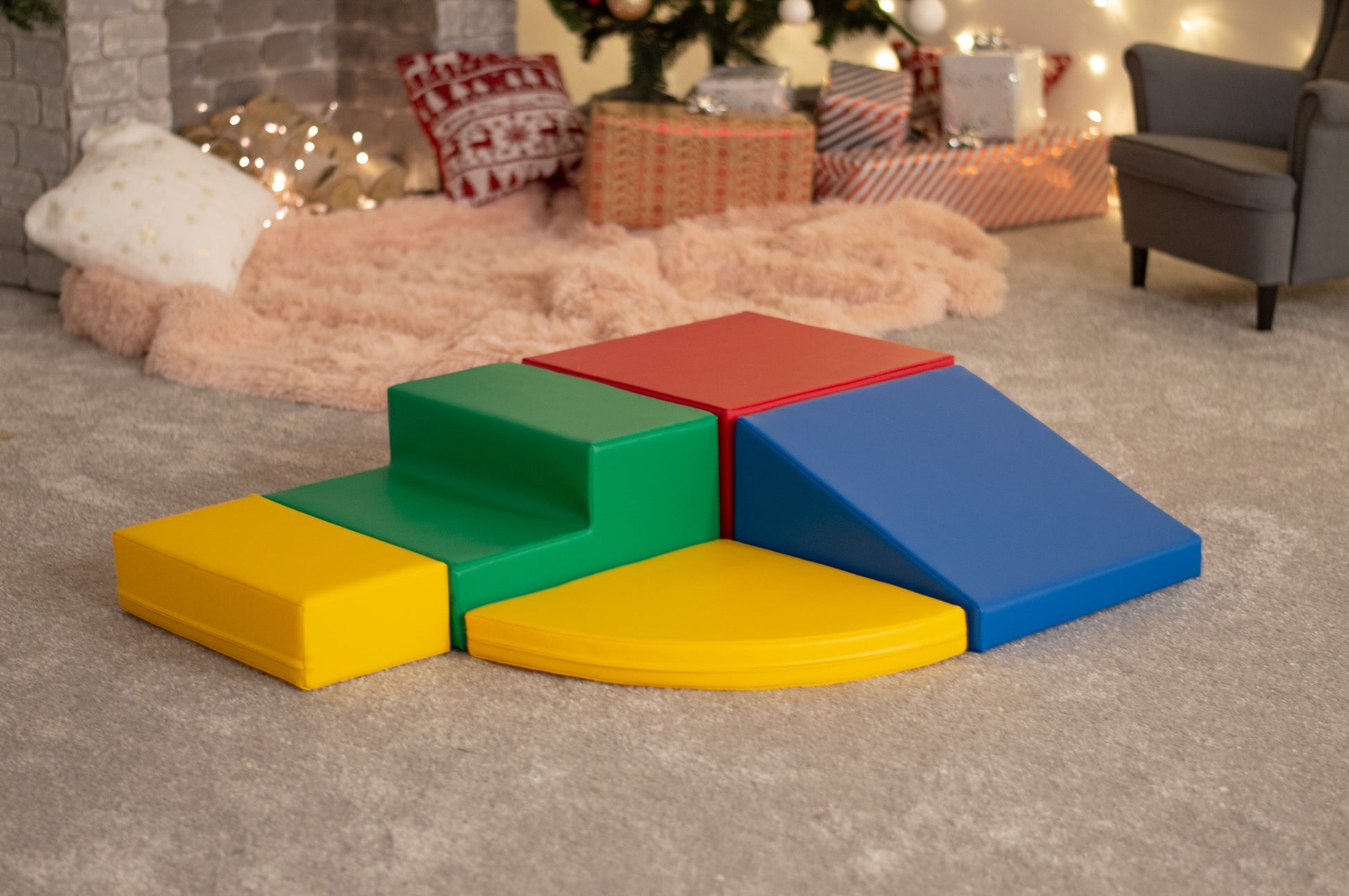 a toddler laughing while climbing a vibrant multicolor iglu foam block corner climber