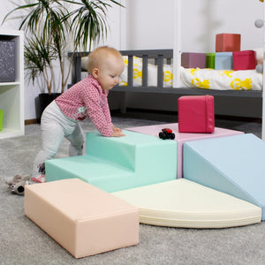 a soft pastel foam corner climber inviting gentle play and cozy moments for toddlers