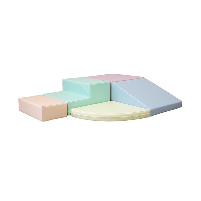 toddler climbing a soft pastel foam corner climber in a sunlit playroom