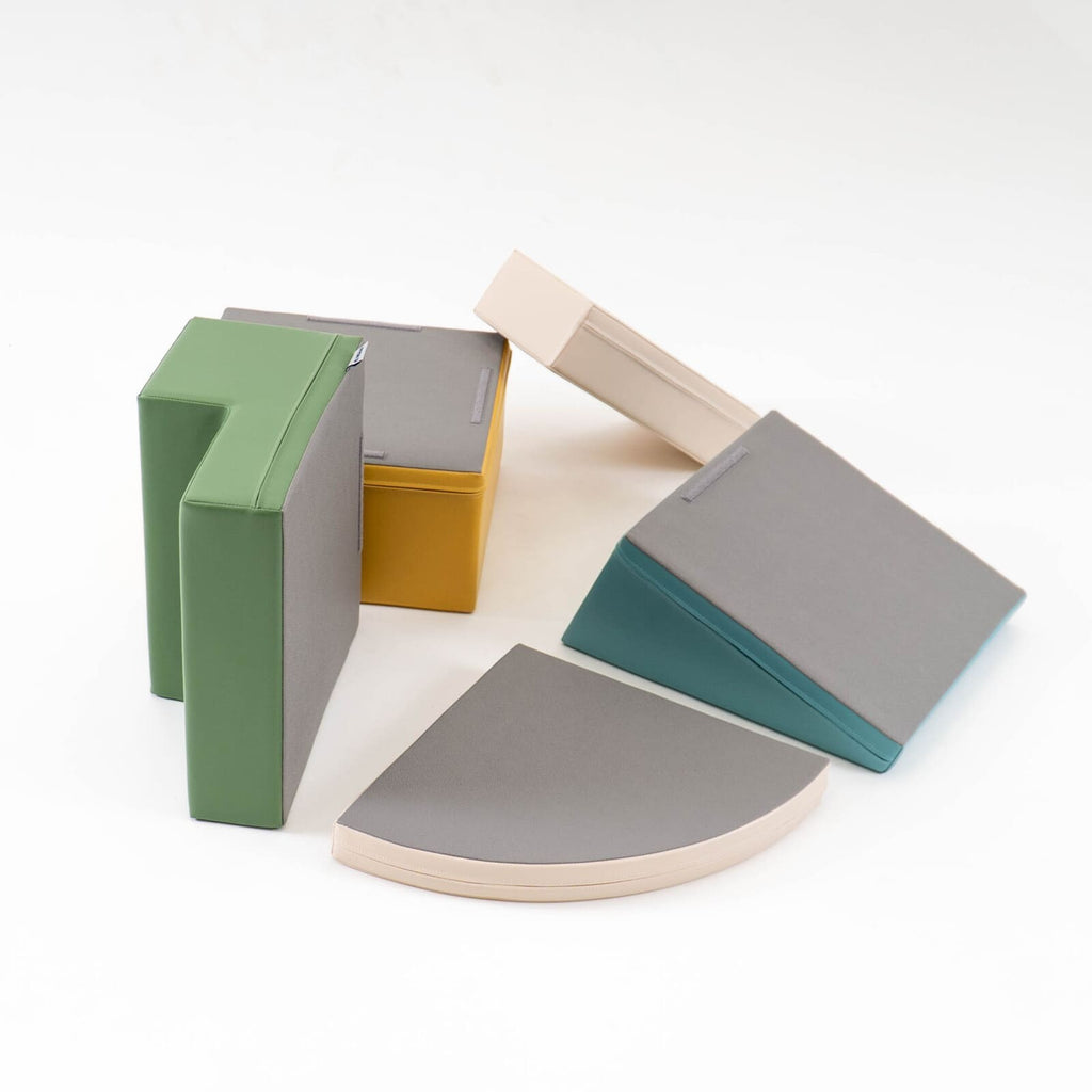 practical setup of a pastel turquoise foam block corner climber in a bright, minimalist playroom