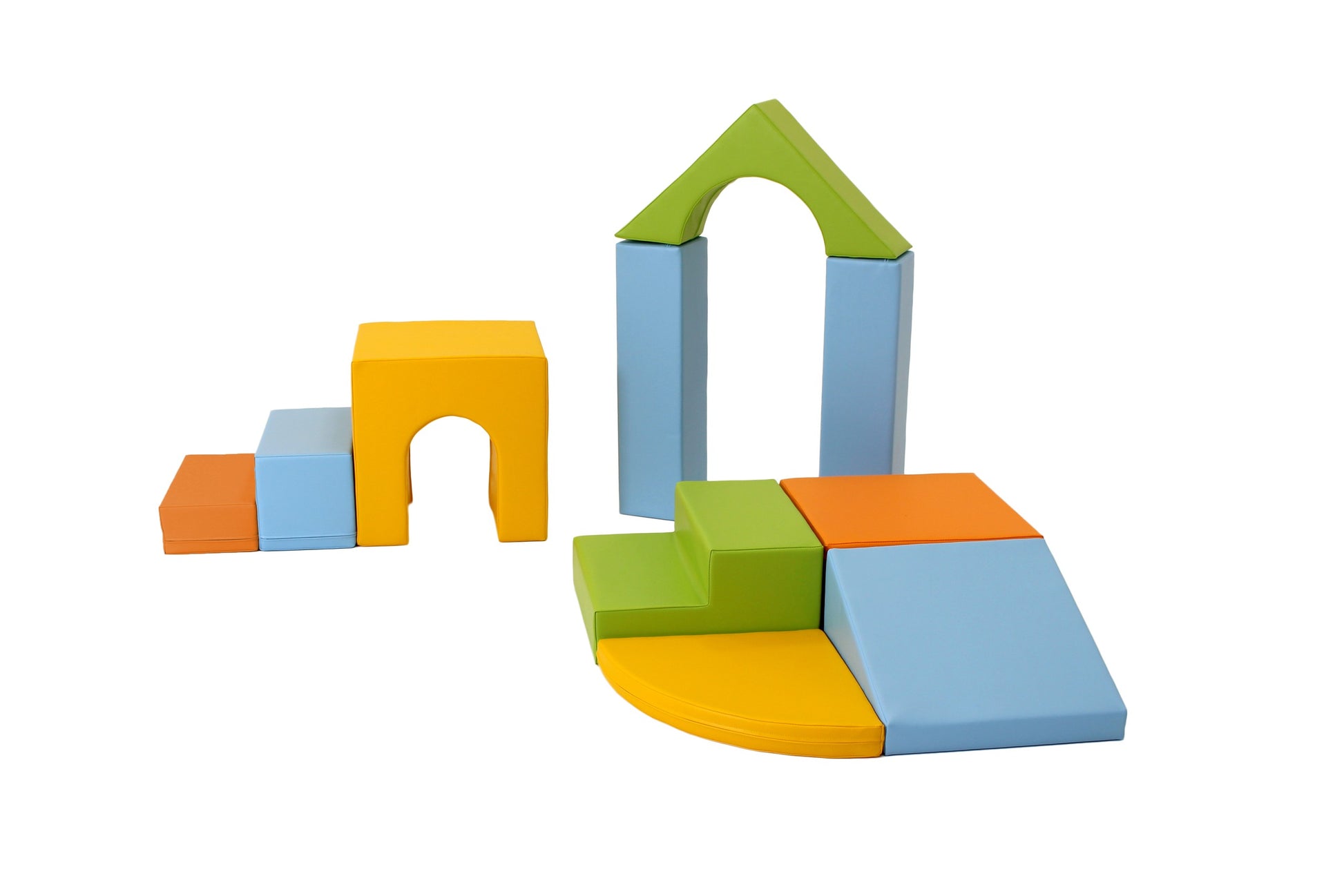 a toddler proudly building a colorful iglu foam block castle on a soft play mat