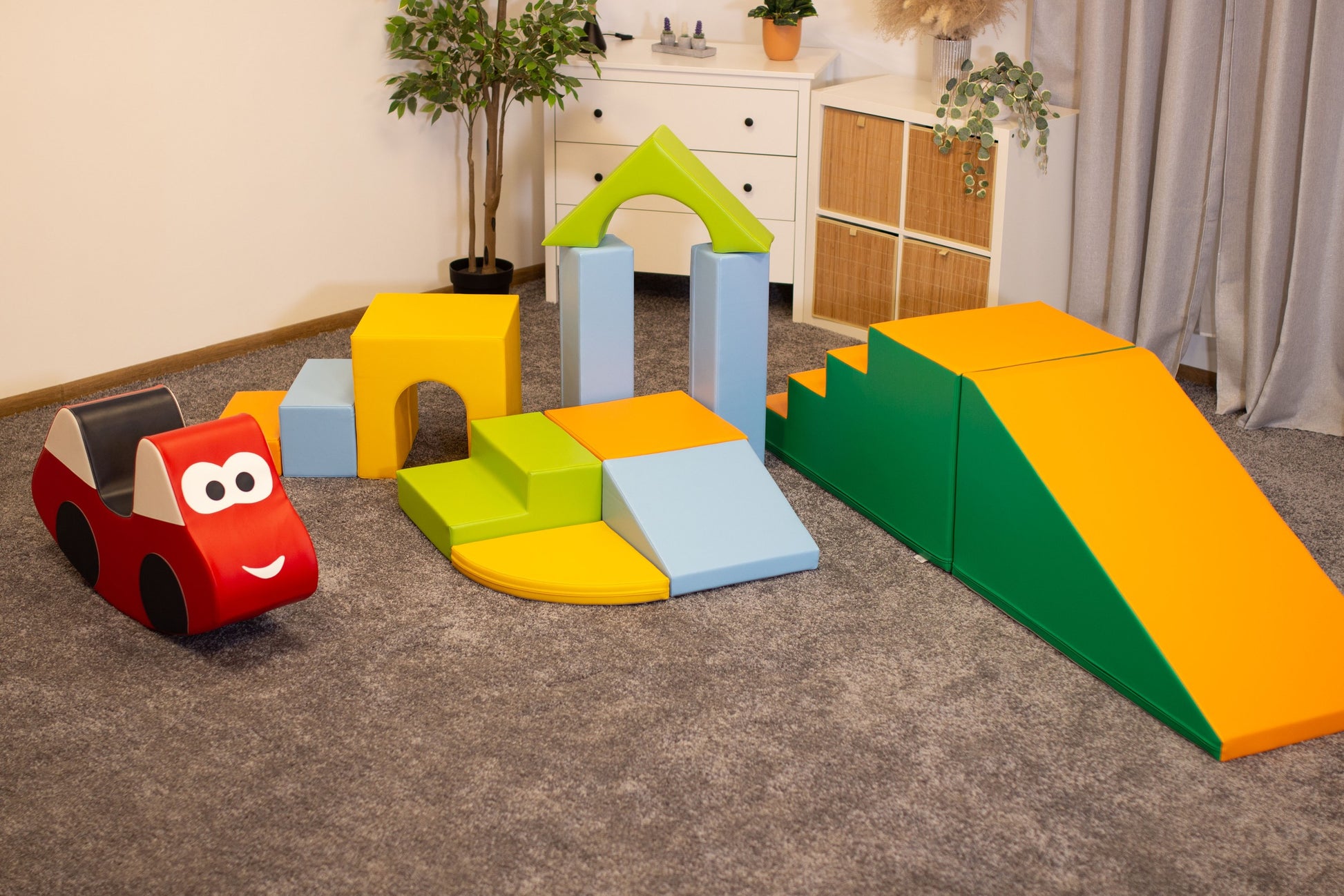 a child's hand placing a soft iglu foam block on a colorful castle structure