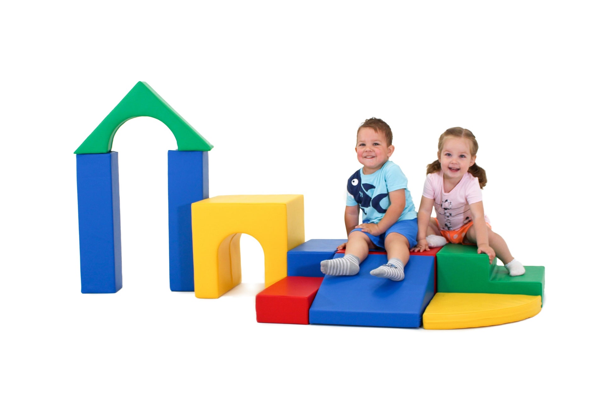 a toddler building a vibrant iglu foam block tower in a sunlit playroom