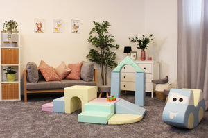 confident toddler building a tall pastel igloo with soft foam blocks